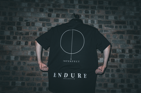 Back view of ENDURE COLLECTIVE oversized graphic T-shirt with Imperfect Circle print