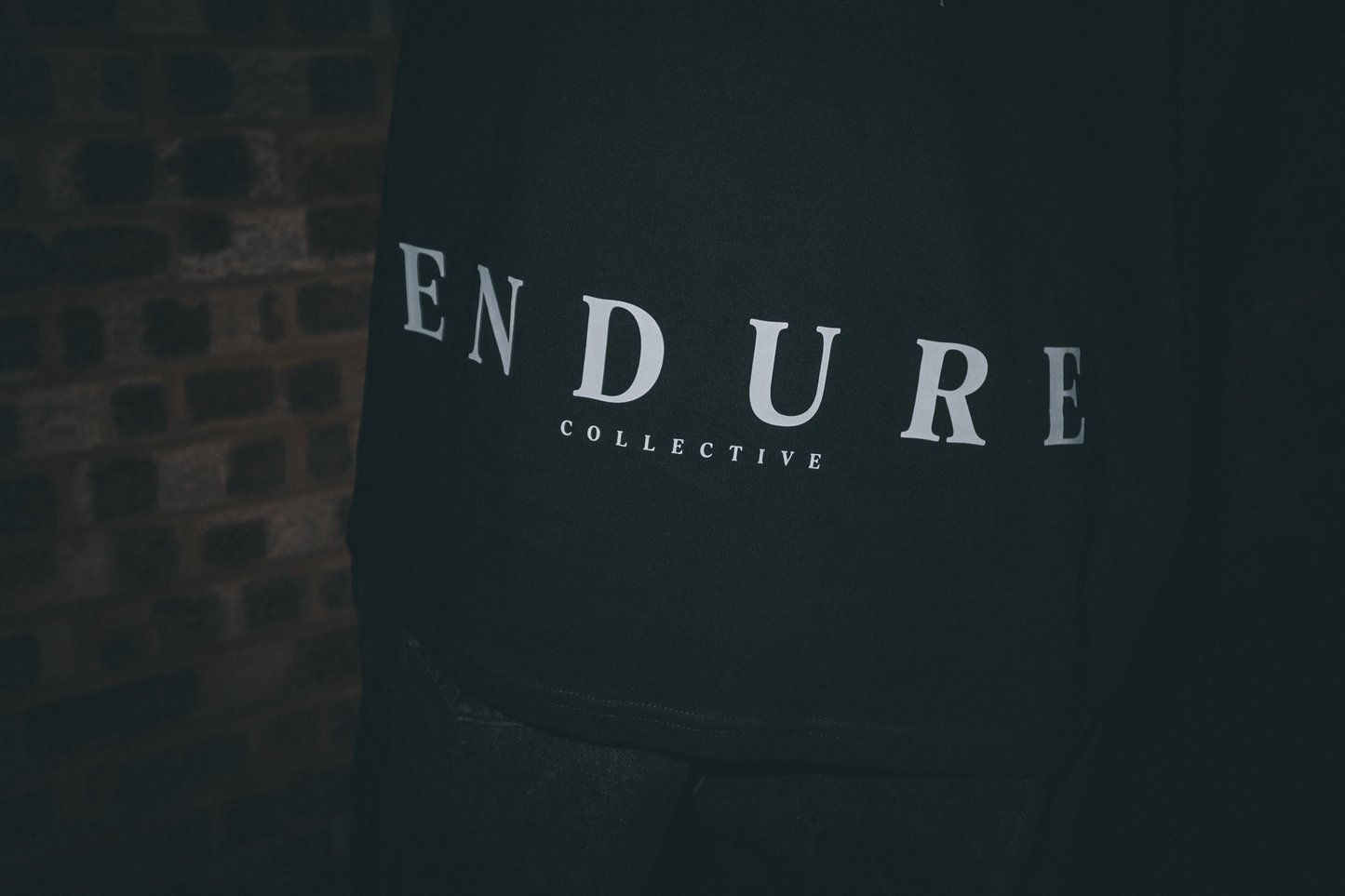ENDURE COLLECTIVE logo detail on Imperfect Circle oversized graphic T-shirt