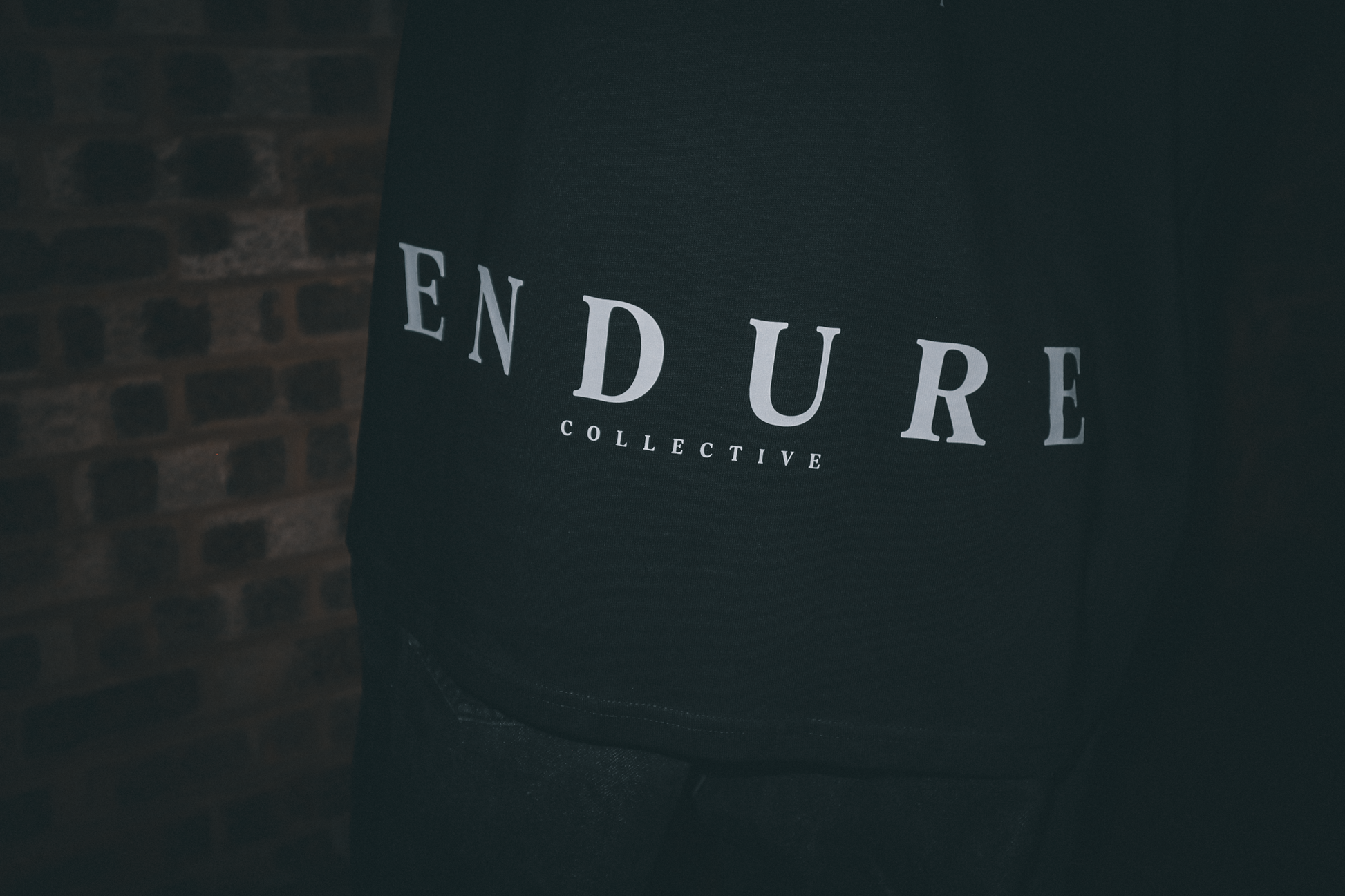 ENDURE COLLECTIVE logo detail on Imperfect Circle oversized graphic T-shirt