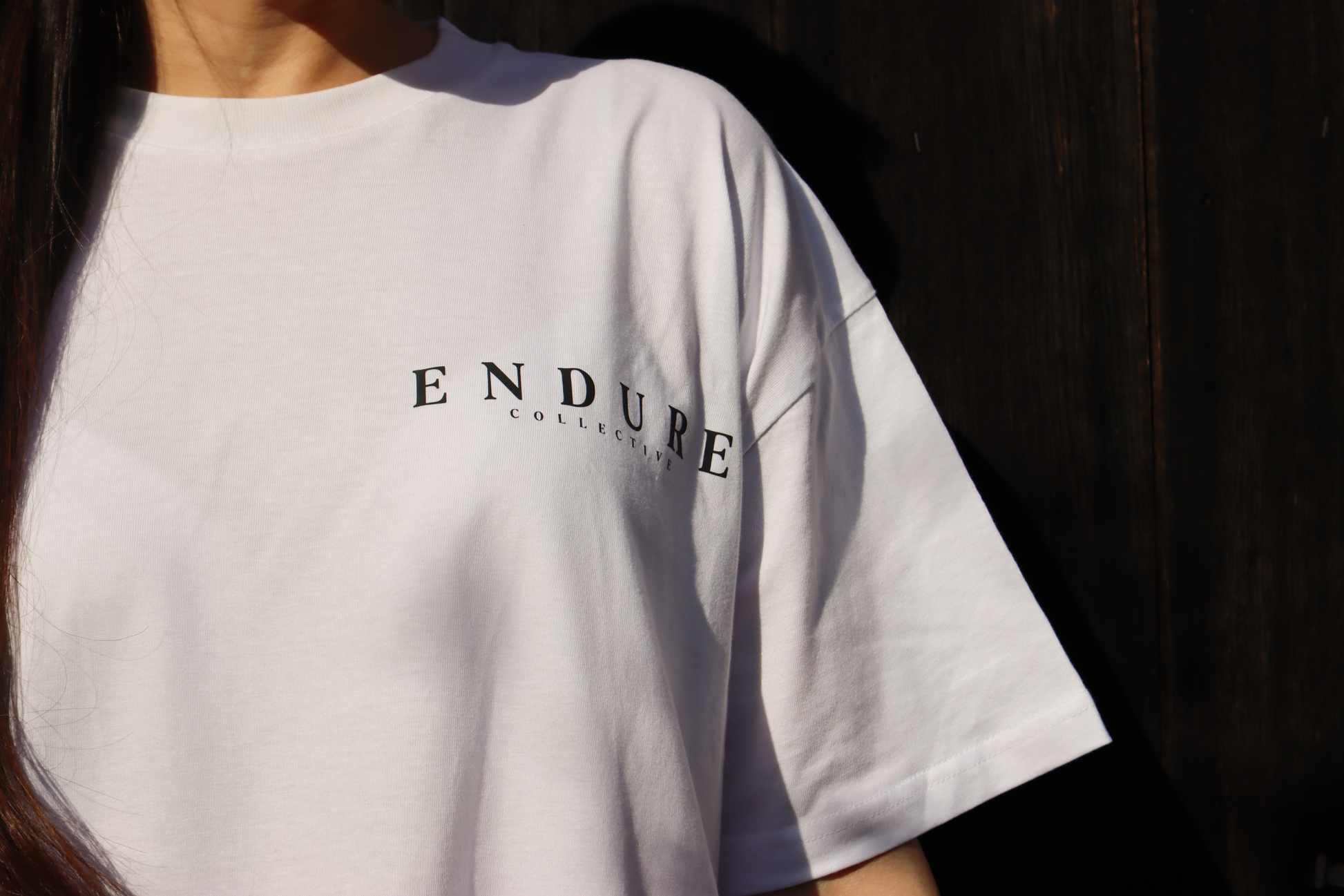 White Genesis 1:3 oversized T-shirt with ENDURE COLLECTIVE front chest logo, faith-based streetwear made to order.