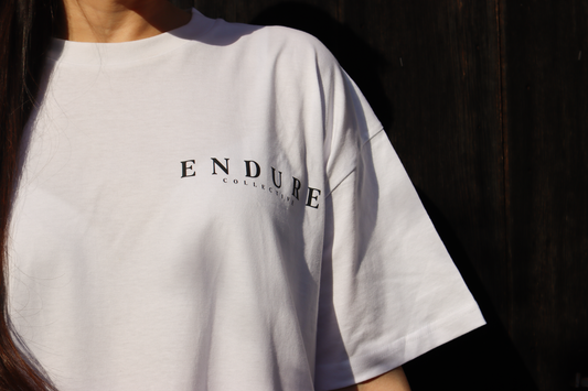 White Genesis 1:3 oversized T-shirt with ENDURE COLLECTIVE front chest logo, faith-based streetwear made to order.